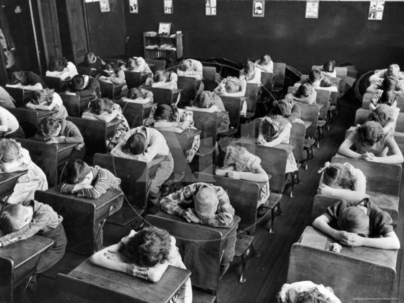 Elementary School Children with Heads Down on Desk During Rest Period in Classroom - Premium Photographic Print
