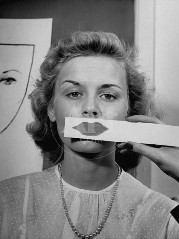 Young Girl Trying to Determine Which Lipstick Color Will Look Right with Her Complextion - Photographic Print