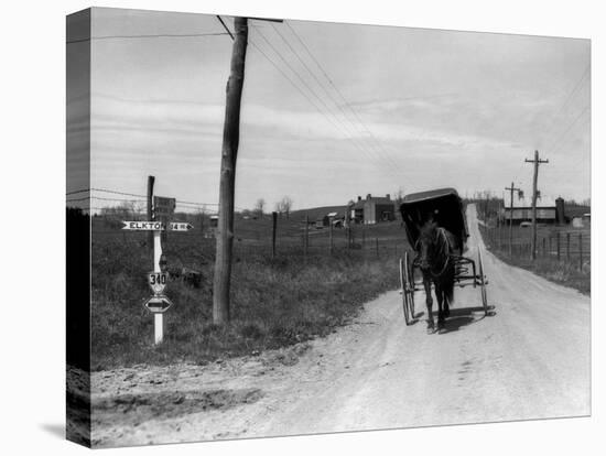 1920s-1930s Amish Man Driving Buggy Down Rural Dirt Road in Farm Country-null-Premier Image Canvas