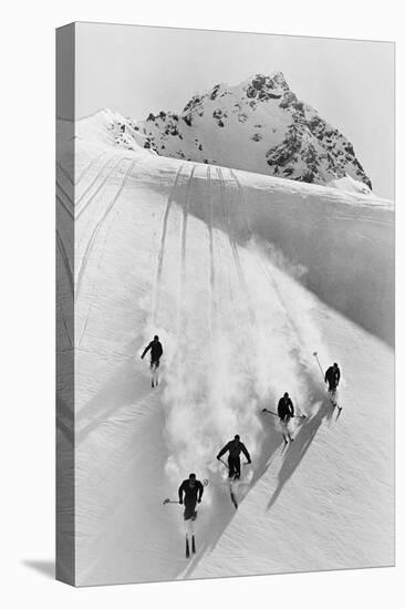 1920s 1930s FIVE ANONYMOUS MEN SKIING DOWN SNOW COVERED ALPS SWITZERLAND-H. Armstrong Roberts-Premier Image Canvas