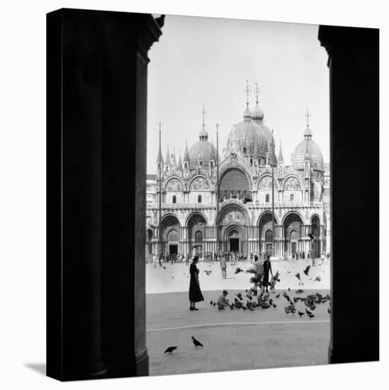 1920s 1930s VIEW THROUGH DOORWAY TO PEOPLE FEEDING PIGEONS IN FRONT OF ST. MARKS CATHEDRAL VENIC...-H. Armstrong Roberts-Premier Image Canvas
