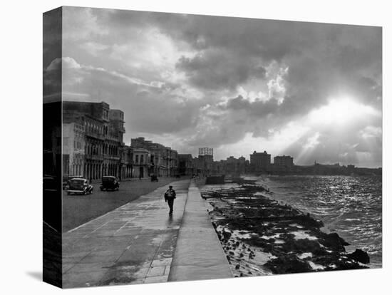 1930s-1940s Anonymous Silhouetted Man Walking Along Havana Sea Wall at Sunset Cuba-null-Premier Image Canvas