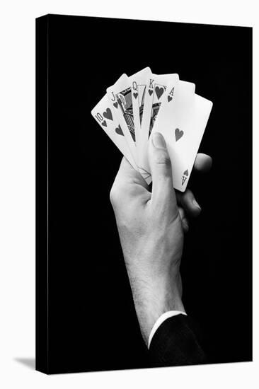 1930s MAN'S HAND HOLDING 5 PLAYING CARDS A POKER HAND THAT IS A ROYAL STRAIGHT FLUSH IN HEARTS-H. Armstrong Roberts-Premier Image Canvas