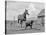 1950s-1960s Black Dog Leading Horse by Holding Rope Halter in His Mouth-null-Premier Image Canvas