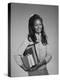1960s AFRICAN AMERICAN TEEN GIRL CARRYING SCHOOL BOOKS-Panoramic Images-Premier Image Canvas