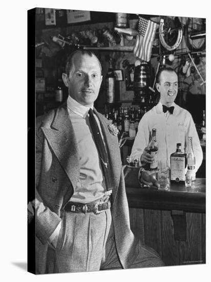 21 Club's Jack Kriendler Relaxing at Bar with Drink, Bartender Holding Bottle on Other Side of Bar-Eric Schaal-Premier Image Canvas