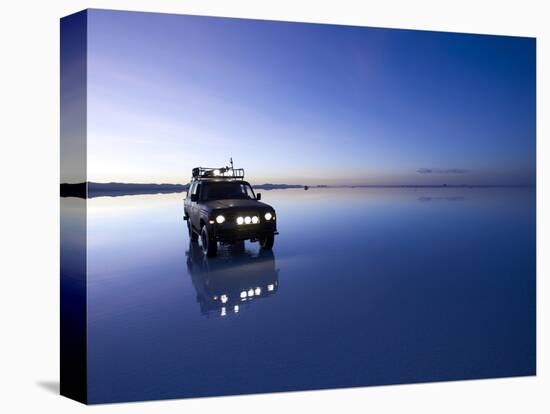 A 4X4 Rests in the Early Am Reflection in a Flooded Salt Flat In-Sergio Ballivian-Premier Image Canvas