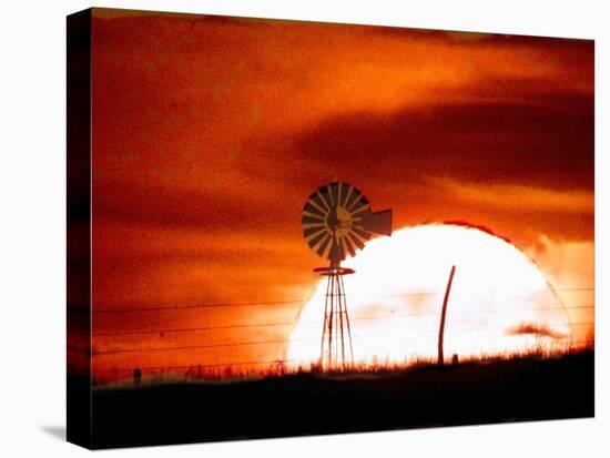 A Blazing Sun Drops Behind a Windmill-null-Premier Image Canvas