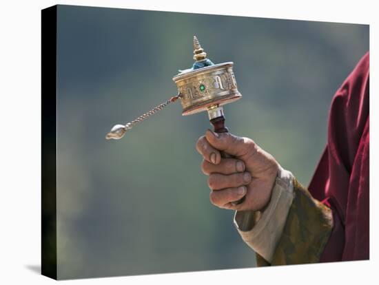 A Buddhist Spins His Hand-Held Prayer Wheel in a Clockwise Direction with the Help of a Weighted Ch-Nigel Pavitt-Premier Image Canvas