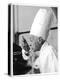 A Chef in a Chef's Hat Tastes Some Soup or Other Food from a Ladle-null-Premier Image Canvas