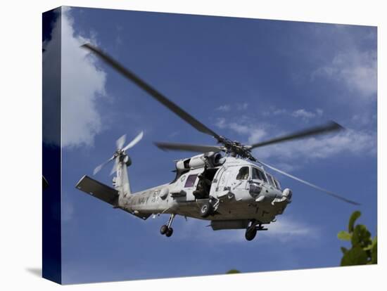 A Crew Chief Looks Out the Side Door of a Helicopter in Flight-null-Premier Image Canvas