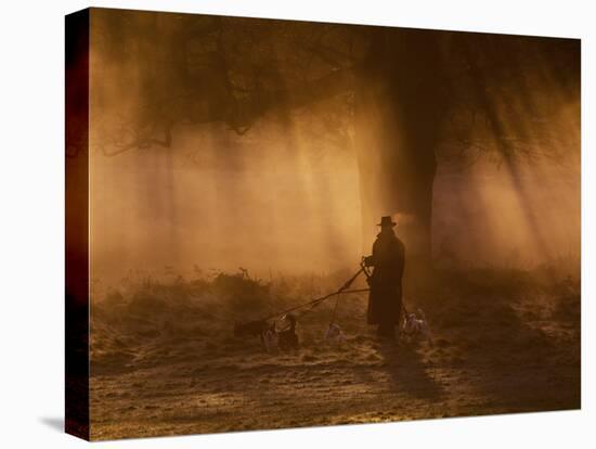 A Dog Walker Makes His Way with Four Dogs in the Early Morning Mist in Richmond Park-Alex Saberi-Premier Image Canvas