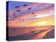 A Flock of Brown Pelicans Fly over the Beach as the Sun Sets-Steve Bower-Premier Image Canvas