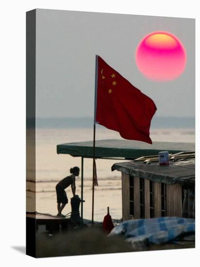 A Girl Rests on a Boat Below the Chinese National Flag-null-Premier Image Canvas