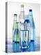 A Glass in Front of Mineral Water Bottles-Alexander Feig-Premier Image Canvas