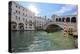 A gondolier rowing under Rialto Bridge in Venice, UNESCO World Heritage Site, Veneto, Italy, Europe-Nando Machado-Premier Image Canvas