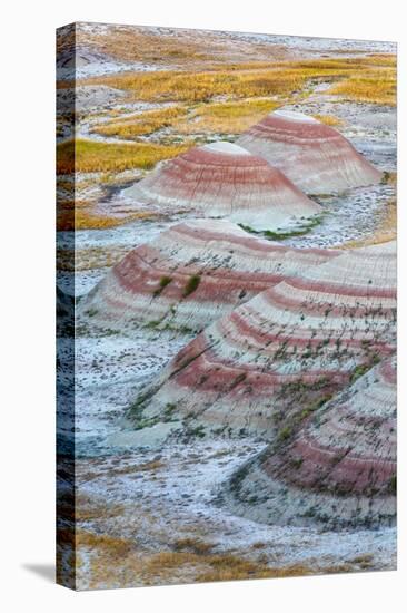 A half circle of rounded mounds or hoodoo, sharply striated with reds.-Sheila Haddad-Premier Image Canvas