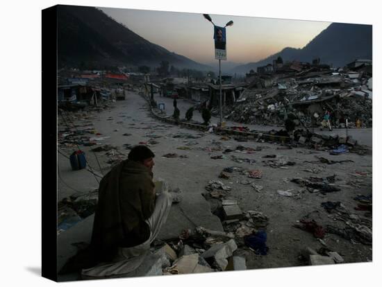 A Homeless Pakistani Earthquake Survivor Sits on the Roadside-null-Premier Image Canvas