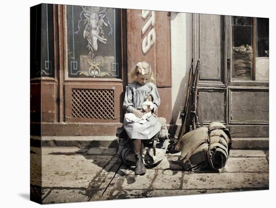 A Little Girl Playing with Her Doll; Two Guns and a Knapsack are Next to He-Fernand Cuville-Premier Image Canvas