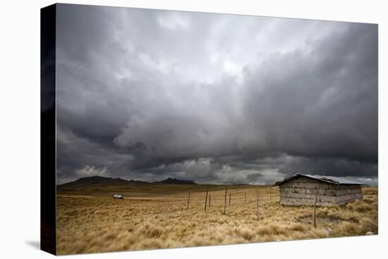 A Lone Hut Sits In The Grass As Storm Clouds Brew Over The Peruvian Countryside-Karine Aigner-Premier Image Canvas