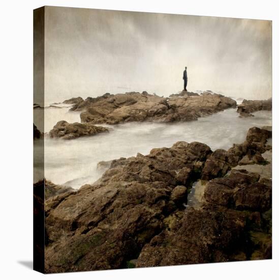 A Lone Man Standing on Large Rocks with the Seas Swirling around Them-Luis Beltran-Premier Image Canvas