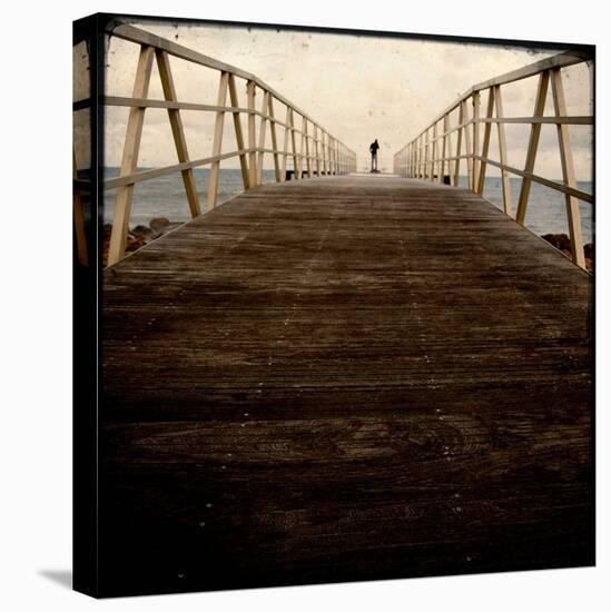 A Long Wooden Walkway at the Sea with a Figure Standing in the Distance-Luis Beltran-Premier Image Canvas