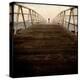 A Long Wooden Walkway at the Sea with a Figure Standing in the Distance-Luis Beltran-Premier Image Canvas
