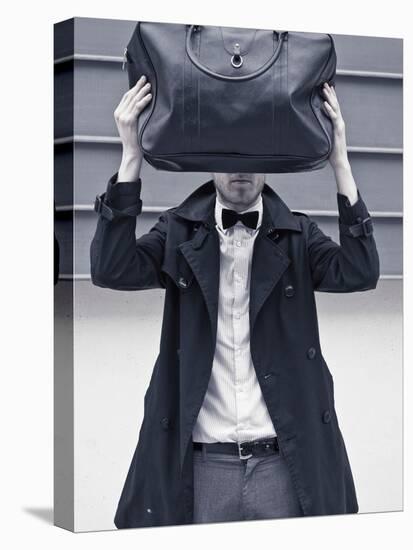 A Man Wearing a Bow Tie Hiding Behind a Bag-India Hobson-Premier Image Canvas