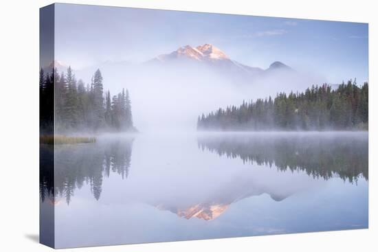 A mist shrouded Pyramid Mountain reflected in Pyramid Lake at dawn, Jasper National Park, Alberta, -Adam Burton-Premier Image Canvas