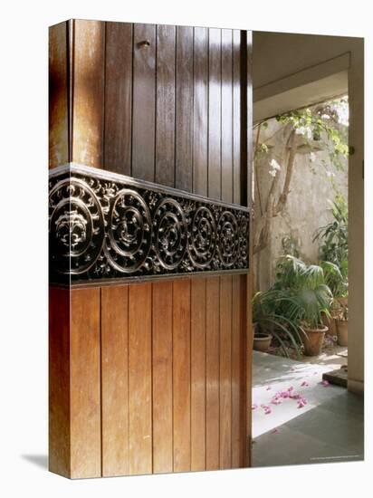 A Modern Front Door Decorated with a 400 Year Old Piece of Wood Carving-John Henry Claude Wilson-Premier Image Canvas
