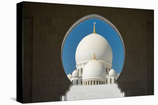 A mosque is framed by an arched passageway in Abu Dhabi, United Arab Emirates, Middle East-Logan Brown-Premier Image Canvas