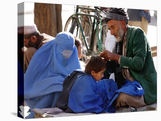 A Mother Watches as Her Child Gets a Haircut in the Center of Kabul, Afghanistan on Oct. 9, 2003.-null-Premier Image Canvas