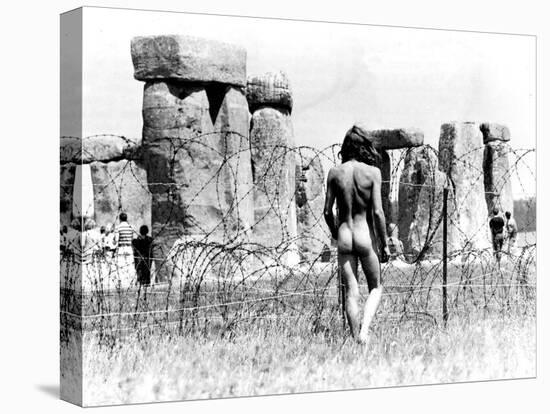 A Naked Hippy Watches Stonehenge from Behind Barb Wire on Summer Solstice-null-Premier Image Canvas