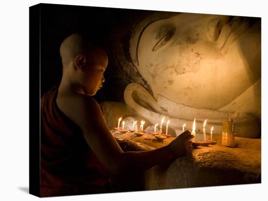 A Novice Monk Lighting Candles at a Massive Buddha Statue in Burma (Myanmar)-Kyle Hammons-Premier Image Canvas