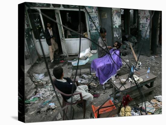 A Pakistani Barber Gives a Haircut and Beard Trim to a Customer-null-Premier Image Canvas