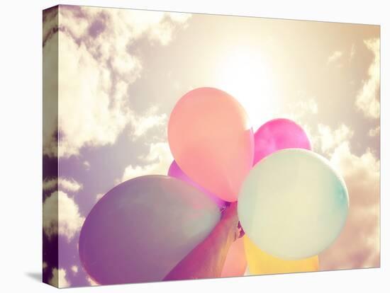 A Person Holding Multi Colored Balloons Done with a Retro Vintage Instagram Filter Effect-graphicphoto-Premier Image Canvas