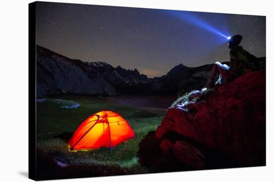 A person looks at stars near his red tent, Unterer Segnesboden, Flims, Switzerland-Francesco Bergamaschi-Stretched Canvas