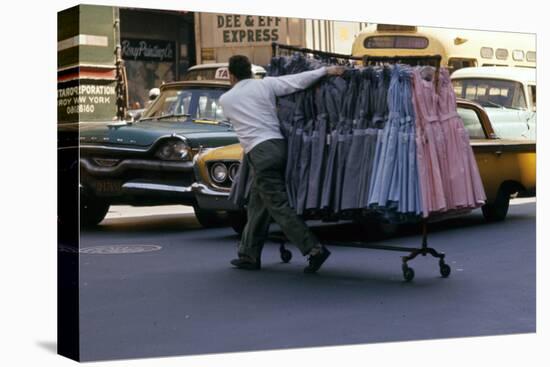 A Push Boy Steers a Rack of Dresses across an Intersection, New York, New York, 1960-Walter Sanders-Premier Image Canvas