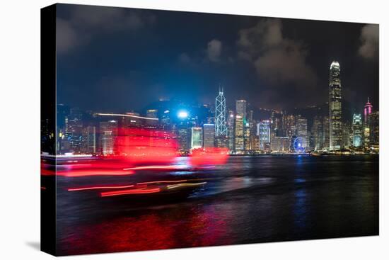 A red junk sailboat glides in front of the Hong Kong skyline at night, Hong Kong, China, Asia-Logan Brown-Premier Image Canvas