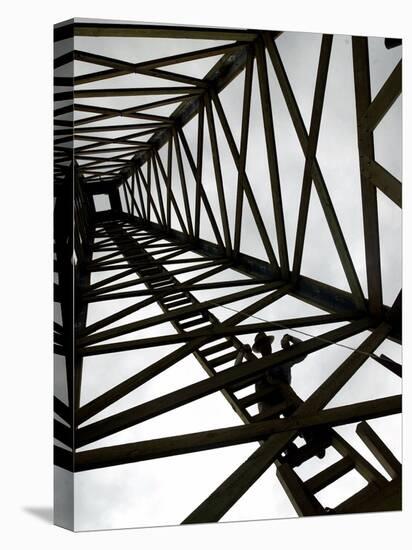 A Reenactor is Silhouetted Inside a Replica of the Spindletop Oil Derrick-null-Premier Image Canvas
