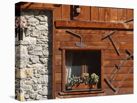 A Rich Wooden Wall with Rustic Tools and Window and a Stone Wall-null-Premier Image Canvas