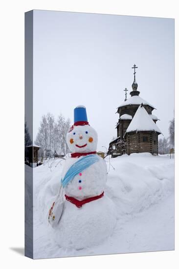 A Snowman and a Wooden Church at the Museum of Wooden Architecture and Peasants' Life-null-Premier Image Canvas