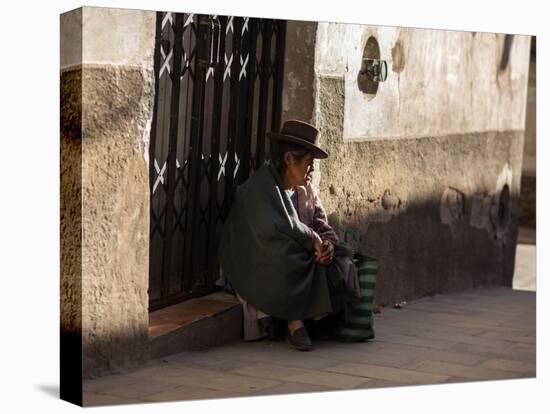 A Traditional Bolivian Woman Sits on a Doorstep in Potosi at Sunset-Alex Saberi-Premier Image Canvas