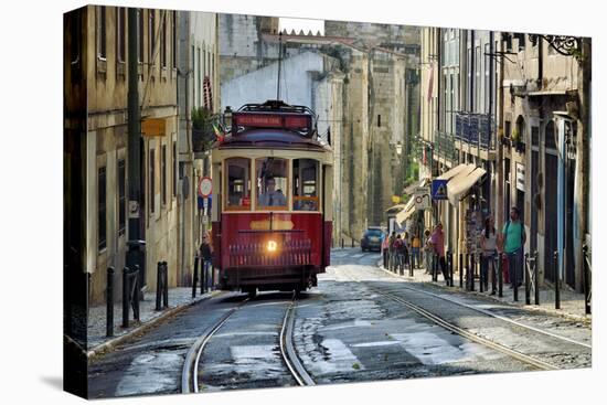 A tramway in Alfama district with the Motherchurch (Se Catedral) in the background. Lisbon, Portuga-Mauricio Abreu-Premier Image Canvas