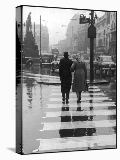 A Typical English Street on a Rainy Shopping Day: an Elderly Couple Use the Zebra Crossing-Henry Grant-Premier Image Canvas