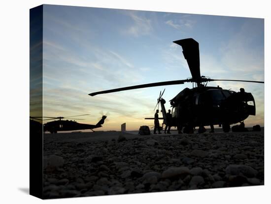 A UH-60 Black Hawk Helicopter on the Flight Line at Sunset-null-Premier Image Canvas