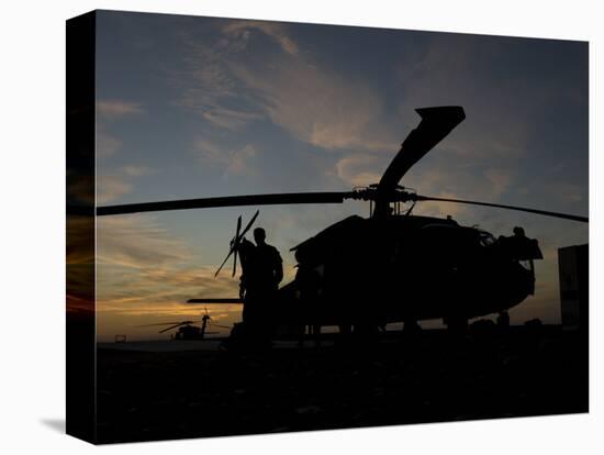 A UH-60 Black Hawk Helicopter on the Flight Line at Sunset-null-Premier Image Canvas