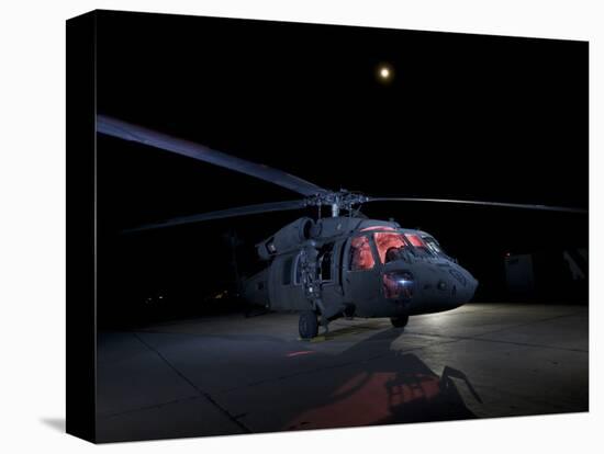A UH-60 Black Hawk Helicopter Parked on the Flight Line under a Full Moon-null-Premier Image Canvas