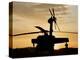 A UH-60L Black Hawk Helicopter Silhouetted by the Setting Sun-null-Premier Image Canvas