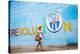 A Woman Walks Past A Propagandistic Mural In Cienfuegos, Cuba-Erik Kruthoff-Stretched Canvas